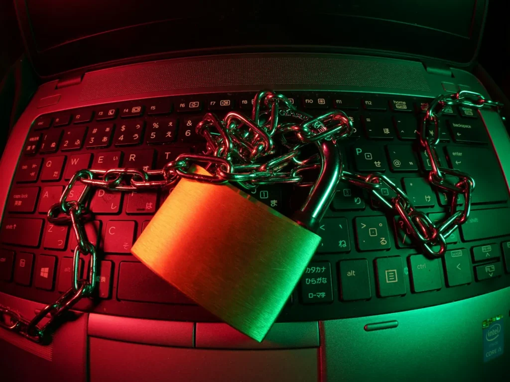 Padlock and chain resting on a laptop keyboard