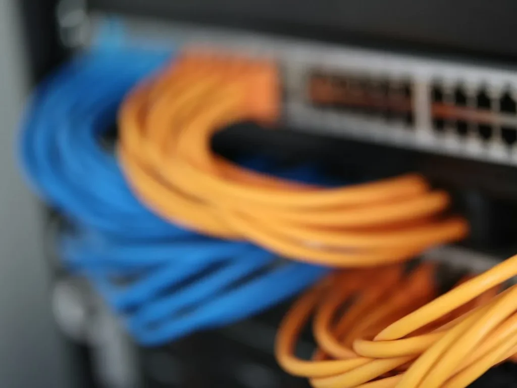 Network switch with neatly run blue and orange patch cables
