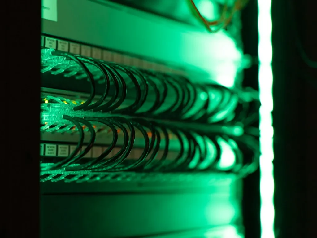 Server rack lit in green in a data centre
